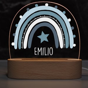 May include: A blue and white rainbow night light with a star and the name "EMILIO" on a wooden base.