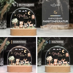 May include: A white acrylic night light with a woodland animal design. The light features a bear, raccoon, deer, and owl. The light is on a wooden base and has a clear acrylic dome. The light has three color temperature settings: neutral white, warm white, and cool white. The light is personalized with the name "Matheo" and the date "10.10.2023".
