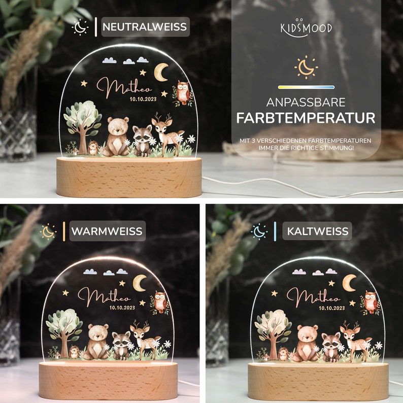 May include: A white acrylic night light with a woodland animal design. The light features a bear, raccoon, deer, and owl. The light is on a wooden base and has a clear acrylic dome. The light has three color temperature settings: neutral white, warm white, and cool white. The light is personalized with the name "Matheo" and the date "10.10.2023".