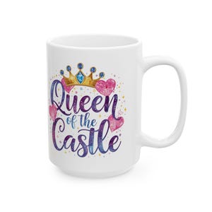 May include: White ceramic mug with the text "Queen of the Castle" in a watercolor style. The design includes a gold crown, pink hearts, and a galaxy-themed background.