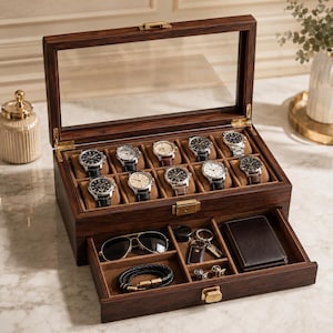 May include: A dark wood watch box with a glass lid featuring ten watch compartments with tan cushions. The box includes a pull-out drawer containing a pair of sunglasses, a black braided bracelet, a keychain, and a dark brown leather wallet.
