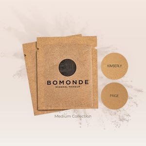 May include: A collection of mineral makeup products. The image features two small, round containers labeled "Kimberly" and "Paige" in a light brown shade. The packaging includes brown paper packets with the "Bomonde Mineral Makeup" logo and the text "Medium Collection."