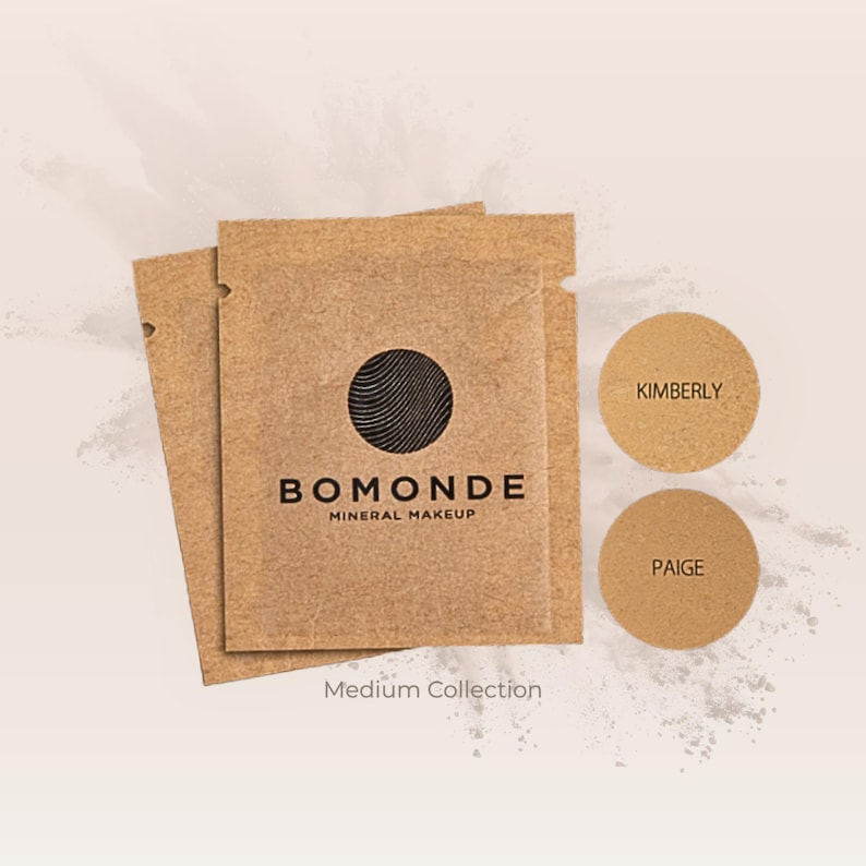 May include: A collection of mineral makeup products. The image features two small, round containers labeled "Kimberly" and "Paige" in a light brown shade. The packaging includes brown paper packets with the "Bomonde Mineral Makeup" logo and the text "Medium Collection."