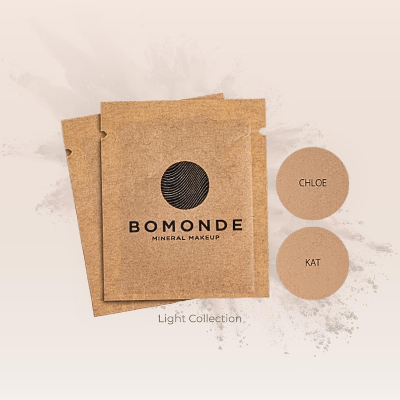May include: A collection of Bomonde mineral makeup products. The image shows two small, round compacts labeled "Chloe" and "Kat" next to several brown paper packets. The packets have the Bomonde logo and the words "Mineral Makeup" printed on them. The text "Light Collection" is also visible.