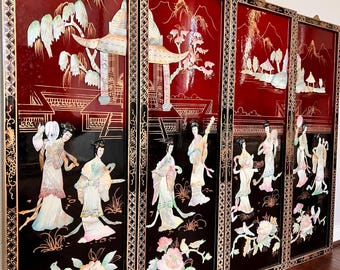 May include: Four-panel Asian screen with a black and red lacquer finish. The panels feature inlaid mother-of-pearl figures and landscapes. The top half of each panel is red with gold accents, while the bottom half is black.