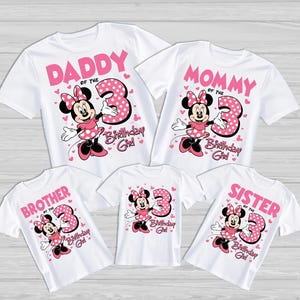 May include: White t-shirts with pink graphics featuring Minnie Mouse and the number 3. The shirts are labeled "Daddy", "Mommy", "Brother", "Sister", and "Birthday Girl". The Minnie Mouse design includes a polka-dot dress and bow.
