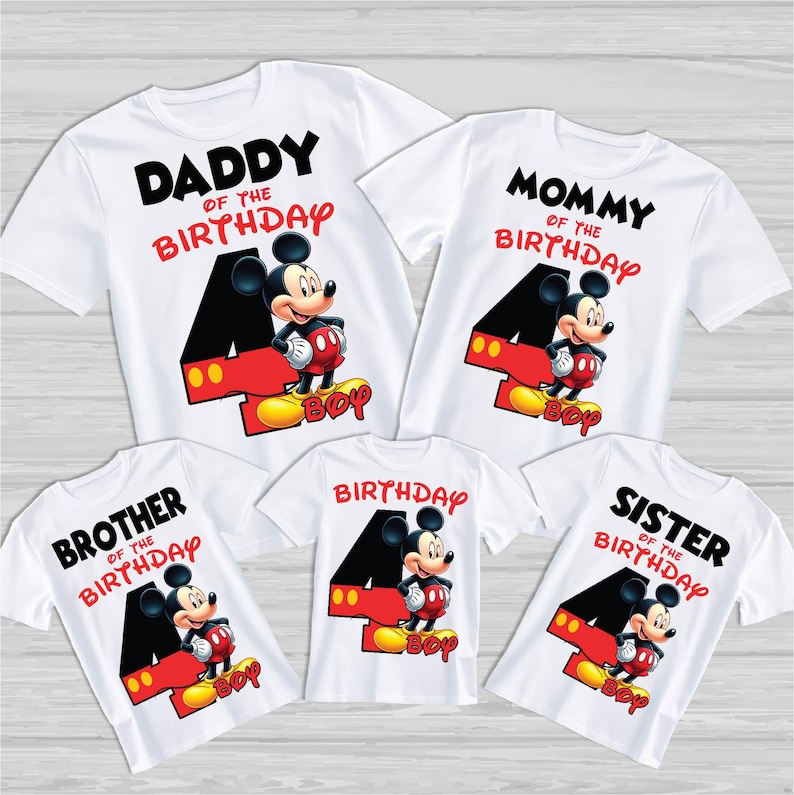 May include: Set of five white t-shirts featuring a Mickey Mouse design. The shirts read "Daddy of the Birthday", "Mommy of the Birthday", "Brother of the Birthday", "Sister of the Birthday", and "Birthday".