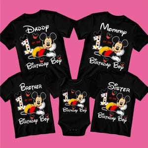 May include: Black family matching shirts and a onesie featuring Mickey Mouse. The shirts say "Daddy", "Mommy", "Brother", and "Sister" with "1 of the Birthday Boy" and Mickey Mouse graphics. The onesie says "Birthday Boy".