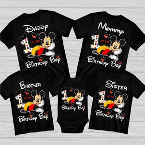 May include: Black family birthday shirts and a onesie featuring Mickey Mouse. The shirts read "Daddy", "Mommy", "Brother", and "Sister", with "1 of the Birthday Boy" and Mickey Mouse graphics. The onesie also has a Mickey Mouse graphic.
