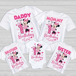 May include: White t-shirts with pink text and Minnie Mouse graphics. The shirts read "Daddy," "Mommy," "Brother," and "Sister" with "of the Birthday Girl." A onesie also reads "Birthday Girl." The number "1" is featured.