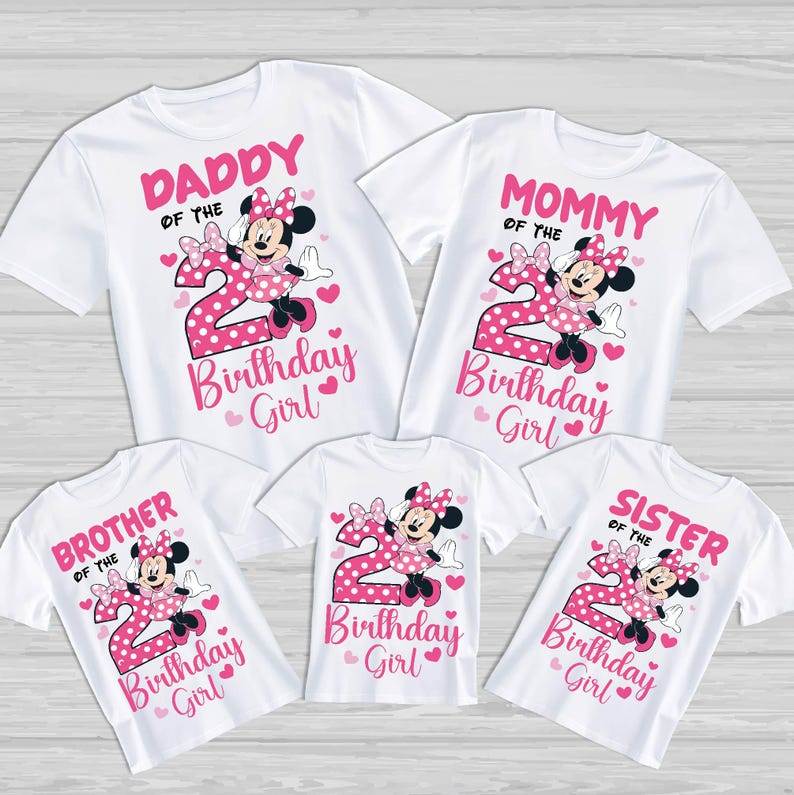 May include: White t-shirts with pink graphics featuring Minnie Mouse and the number 2. The shirts are labeled "Daddy", "Mommy", "Brother", "Sister", and "Birthday Girl". Hearts and polka dots complete the design.