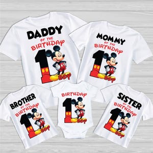 May include: Set of five white t-shirts featuring a cartoon Mickey Mouse character with the text "Daddy of the Birthday", "Mommy of the Birthday", "Brother of the Birthday", "Sister of the Birthday", and "Birthday" on each shirt.