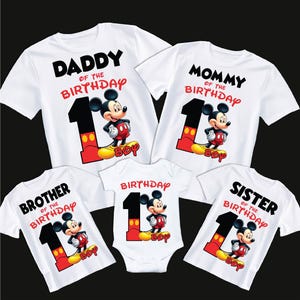 May include: A set of five white t-shirts featuring a Mickey Mouse design with the text "Daddy of the Birthday", "Mommy of the Birthday", "Brother of the Birthday", "Birthday", and "Sister of the Birthday".