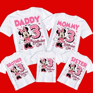 May include: White t-shirts with pink text and Minnie Mouse graphics. The shirts say "Daddy," "Mommy," "Brother," "Sister," and "Birthday Girl" with the number "3." The Minnie Mouse design includes a polka-dot dress and bow.
