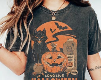 May include: Dark gray t-shirt with a Halloween-themed graphic. The design features a black cat, jack-o'-lantern, bats, and the text "LONG LIVE HALLOWEEN". An orange moon and apple cider bottle are also included.