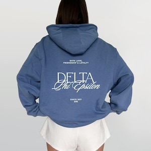 May include: A set of three ceramic mugs with a speckled, matte finish. The mugs are in shades of cream, light brown, and dark brown. Each mug has a simple, minimalist design, perfect for coffee or tea.