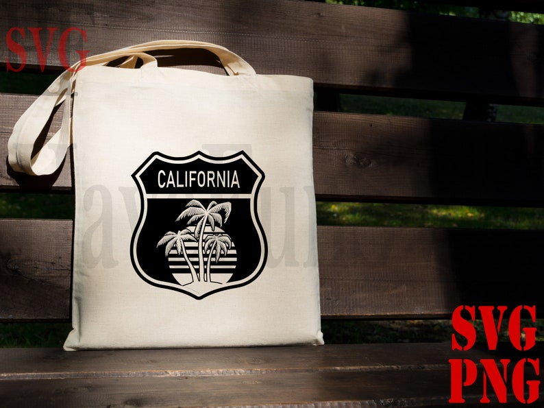 May include: A white tote bag with a black and white graphic of a California road sign with palm trees and the text "CALIFORNIA".