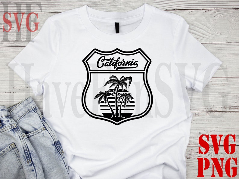 May include: White t-shirt with a black graphic of a California road sign with palm trees and the text "California".