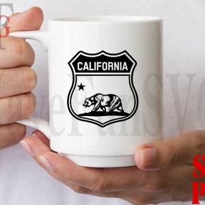 May include: White ceramic mug with a black and white graphic of a California state shield with a bear and the text "CALIFORNIA".