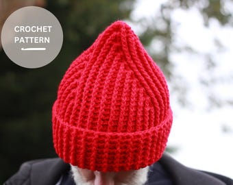 Könnte beinhalten: Eine rote Häkelmütze mit gerippter Struktur.