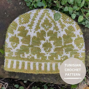 May include: A knit beanie featuring a two-tone olive green and white geometric pattern with a ribbed brim. A circular overlay in the bottom right corner displays the white text TUNISIAN CROCHET PATTERN with a horizontal line underneath.