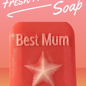 May include: A red soap bar with a white star and the text "Best Mum" in white lettering. The soap is labelled "Fresh Aloe Soap".