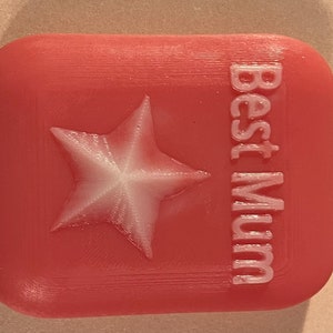 May include: A pink 3D printed box with a white star and the text "Best Mum" on the front.