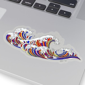 May include: A sticker featuring a colorful illustration of a wave with red, blue, yellow, and white accents.