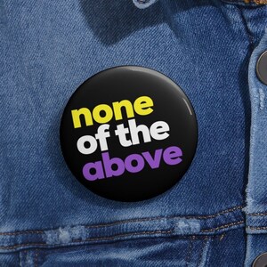 May include: A black button with the text "none of the above" in white, yellow, and purple.