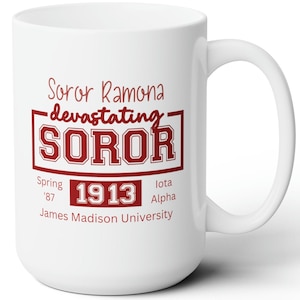 May include: White ceramic mug with a large handle. The mug features maroon text that reads "Soror Ramona devastating SOROR 1913 James Madison University". The mug is a great gift for college students or alumni.