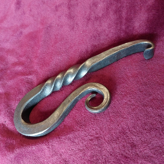 A real blacksmith hand-forged this twisted-steel bottle opener — you can see the hammer marks, and no two are exactly alike.