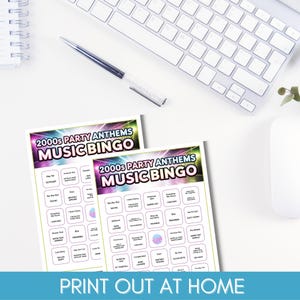 May include: Two "2000s Party Anthems Music Bingo" game cards are displayed with a keyboard, pen, and mouse in the background. The cards have a colourful design with song titles and the text "Print Out At Home".
