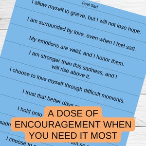 May include: A blue and white printable poster with the text "A Dose of Encouragement When You Need It Most" and a list of positive affirmations for feeling sad.