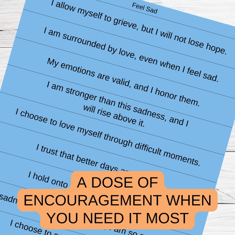 May include: A blue and white printable poster with the text "A Dose of Encouragement When You Need It Most" and a list of positive affirmations for feeling sad.