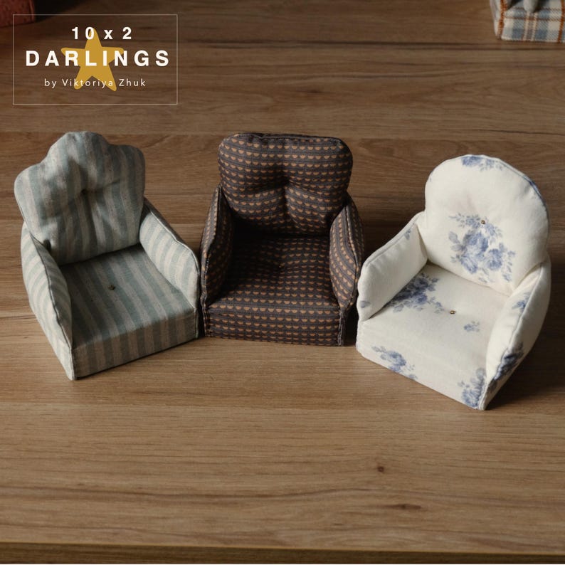 May include: Three miniature armchairs with varied fabric designs. One is striped, another has a heart pattern, and the third features a floral design. The text "10 x 2 DARLINGS by Viktoriya Zhuk" is in the upper left corner.