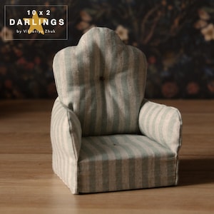 May include: A small armchair with a light green and white striped design. The miniature chair has a button on the backrest and armrests. The text "10 x 2 DARLINGS by Viktoriya Zhuk" is in the upper left corner.