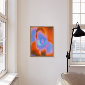 May include: Abstract art print with a vibrant orange, pink, and blue color scheme. The print is framed in a light wood frame.