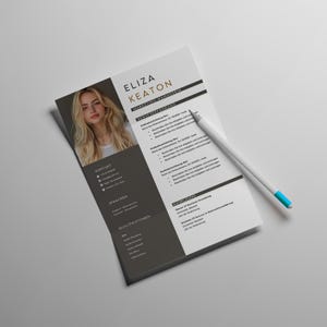 May include: A resume with a photo of a woman with long blonde hair. The resume is titled "Eliza Keaton, Marketing Managerin" and includes sections for experience, education, and skills. A white pencil with a blue tip rests on the resume.