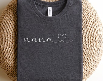 May include: A dark gray t-shirt with the word "nana" and a small heart design in white.