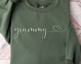 May include: A green sweatshirt with the word "grammy" written in white cursive with a small heart next to it.