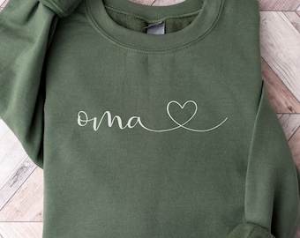 May include: A green sweatshirt with the word "oma" and a heart drawn in white thread.