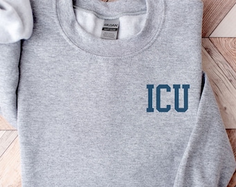 May include: Gray sweatshirt with the text "ICU" in blue on the front.