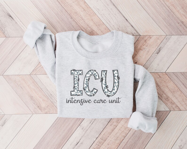 May include: A gray sweatshirt with the words "ICU intensive care unit" printed on the front. The letters are decorated with a floral pattern.