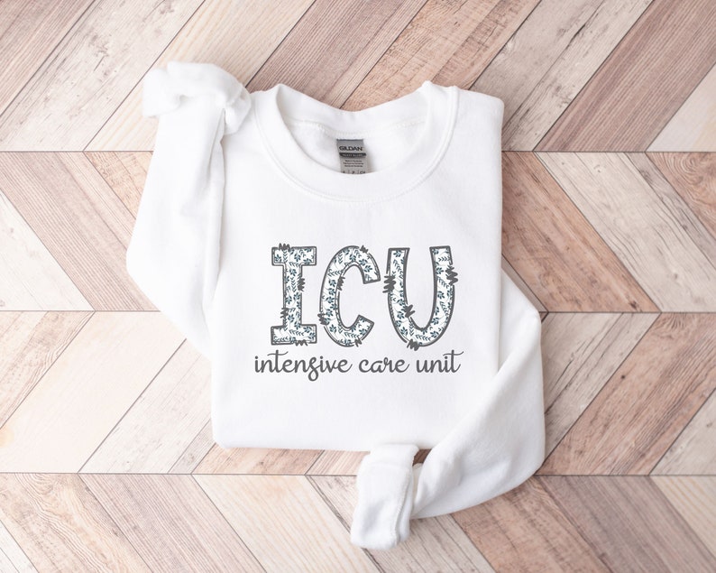May include: White sweatshirt with a floral design that spells out "ICU" and the text "intensive care unit" underneath.