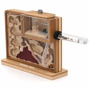 May include: A gold-colored ant farm with a clear viewing area and a connected test tube. The farm has a sand-filled chamber and a red-colored area. The text "Antopia Nests" is visible on the base, and "Expand" is on the clear viewing area.