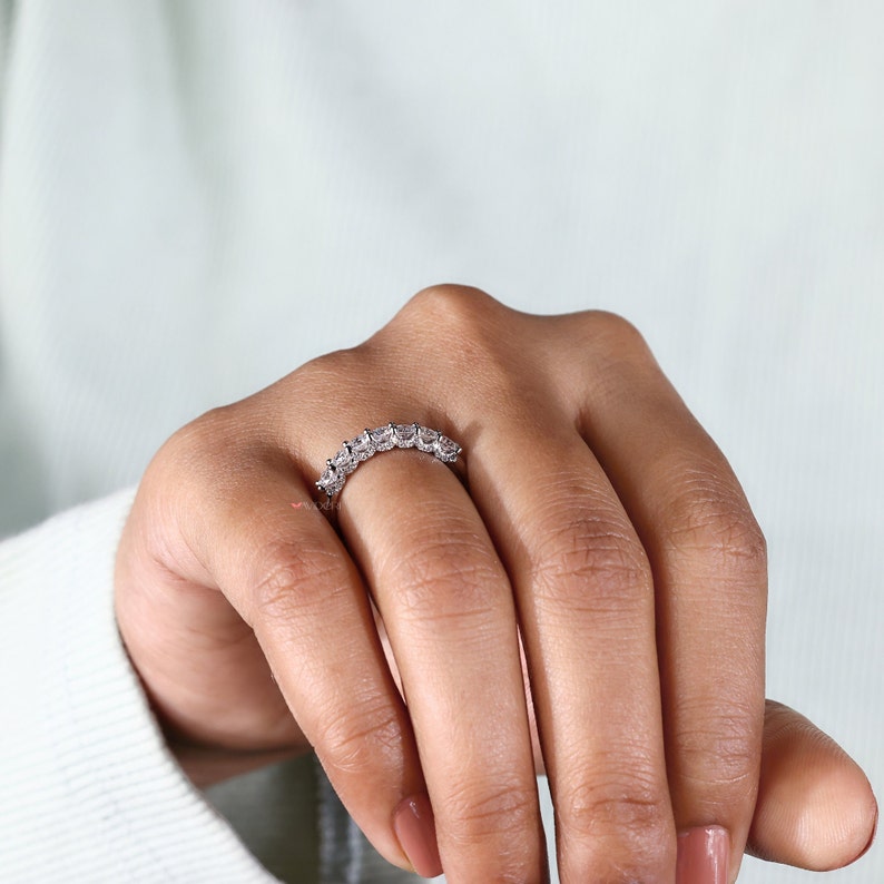 The model hand gracefully resting, with the wedding band prominently visible. This view highlights the band's comfort fit design, making it an ideal choice for everyday wear.