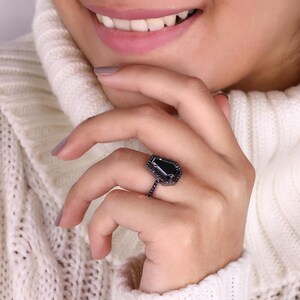 Halo ring with a sparkling centre stone surrounded by smaller gems.