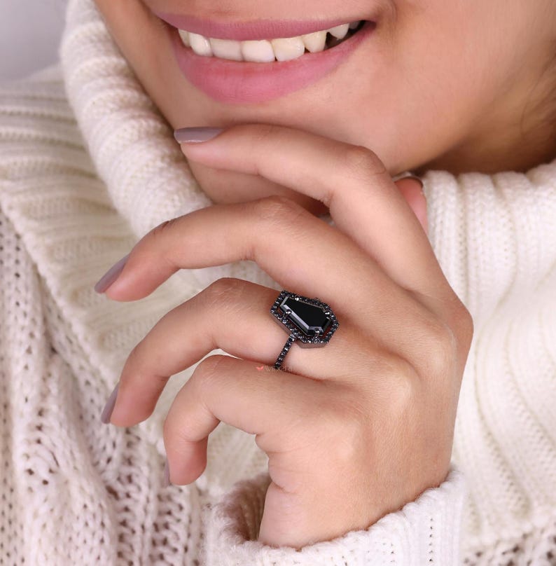 Halo ring with a sparkling centre stone surrounded by smaller gems.