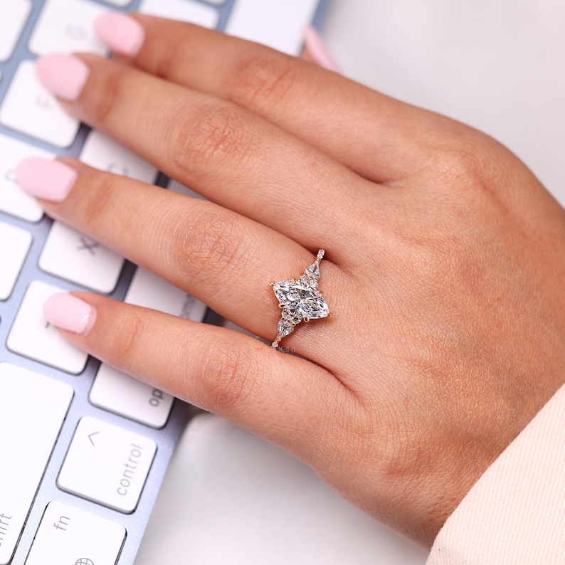 Kite side diamond ring with tapered shank design.