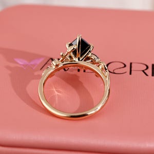 Black stone engagement ring in leaf style prong design.